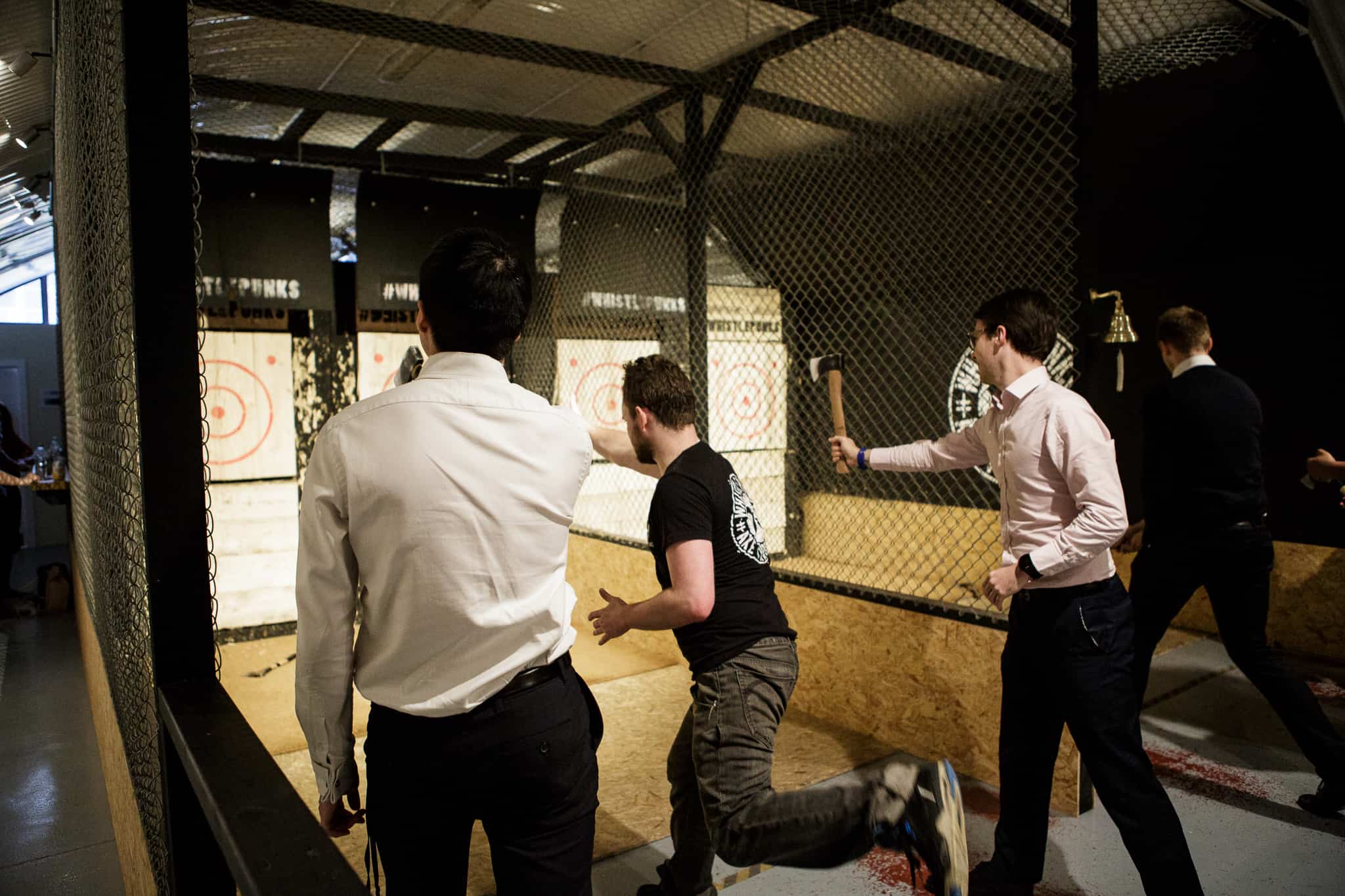 men in business clothes throwing axes