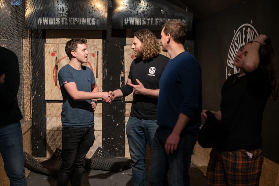 men shaking hands after axe throwing