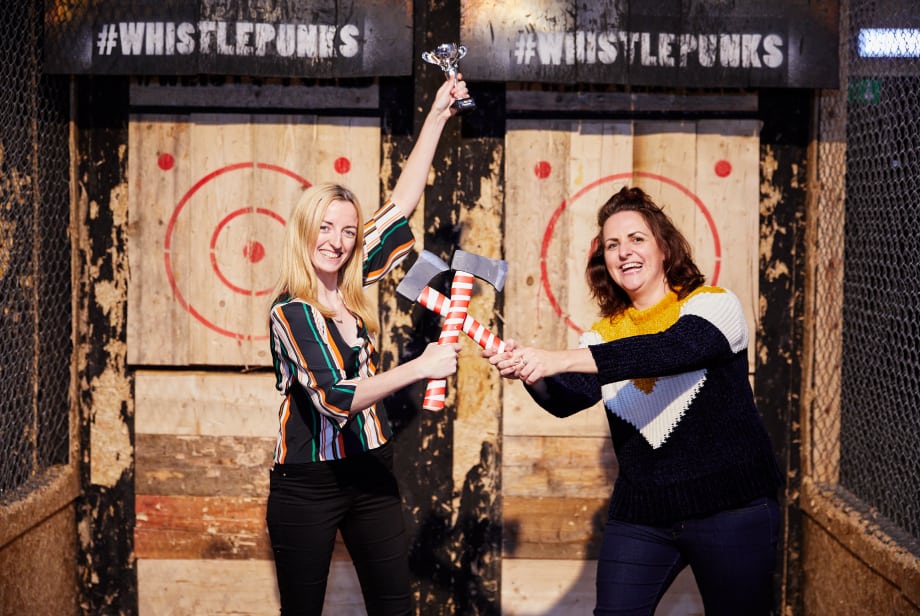 2 women celebrating with axe throwing throphy