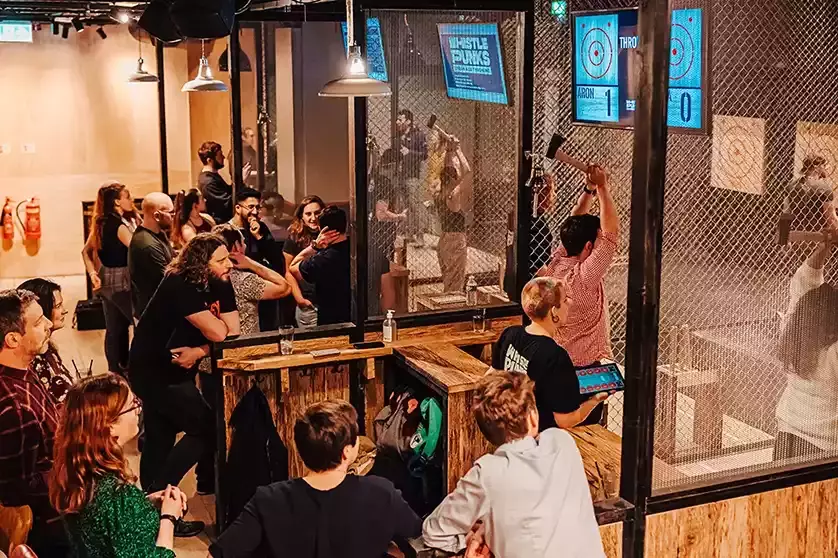 An axe-throwing venue with separate lanes for each group.