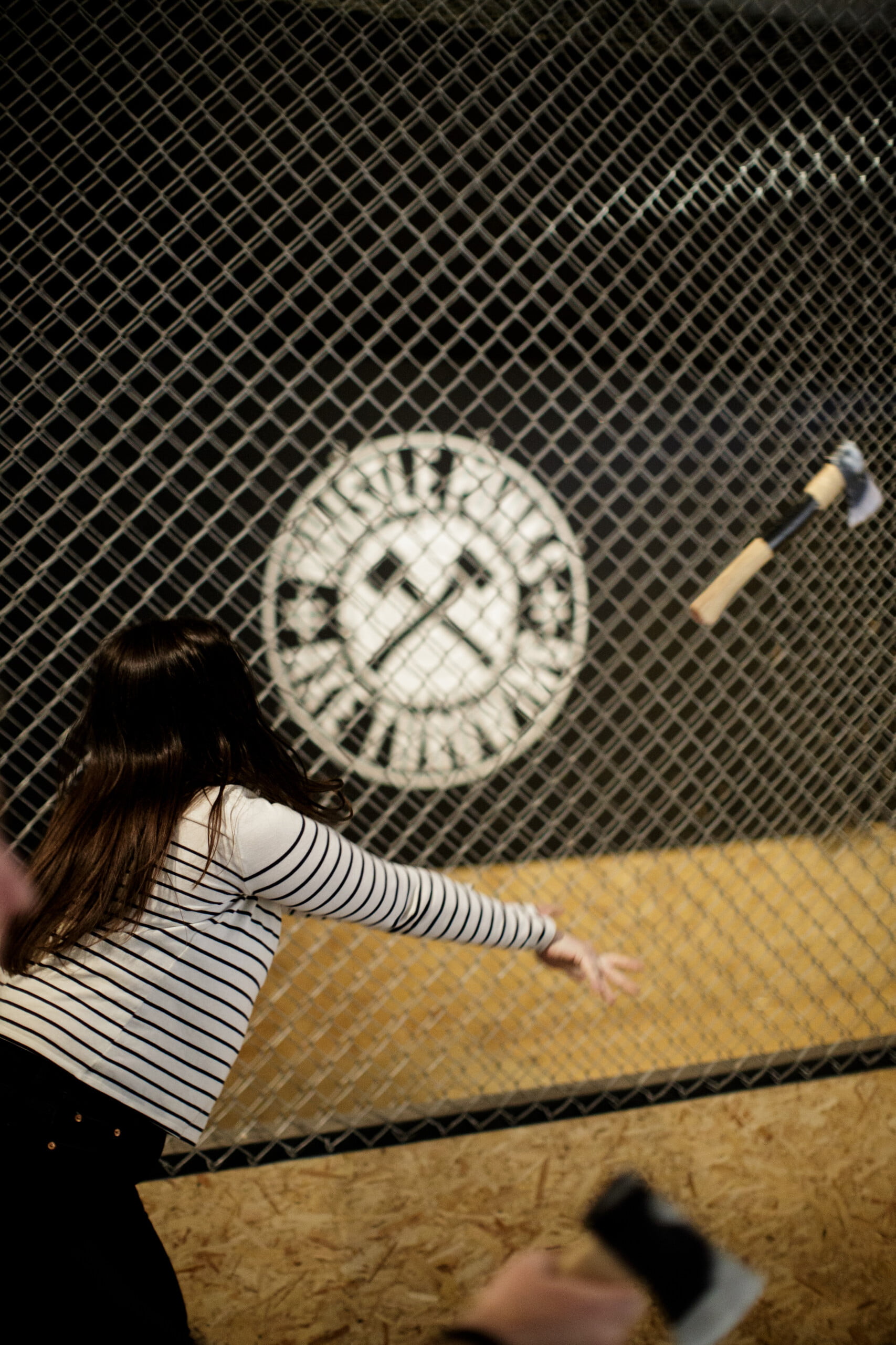 woman throwing an axe at whistle punks